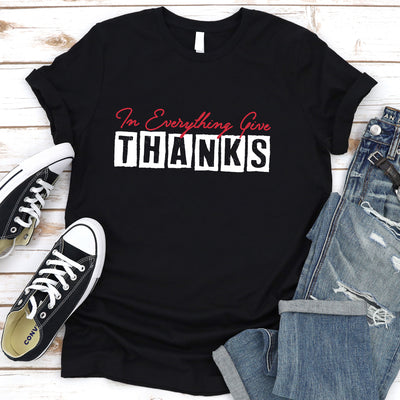 Black t-shirt with message, reads "in Everything Give Thanks" In Everything Give -in scripted in red.