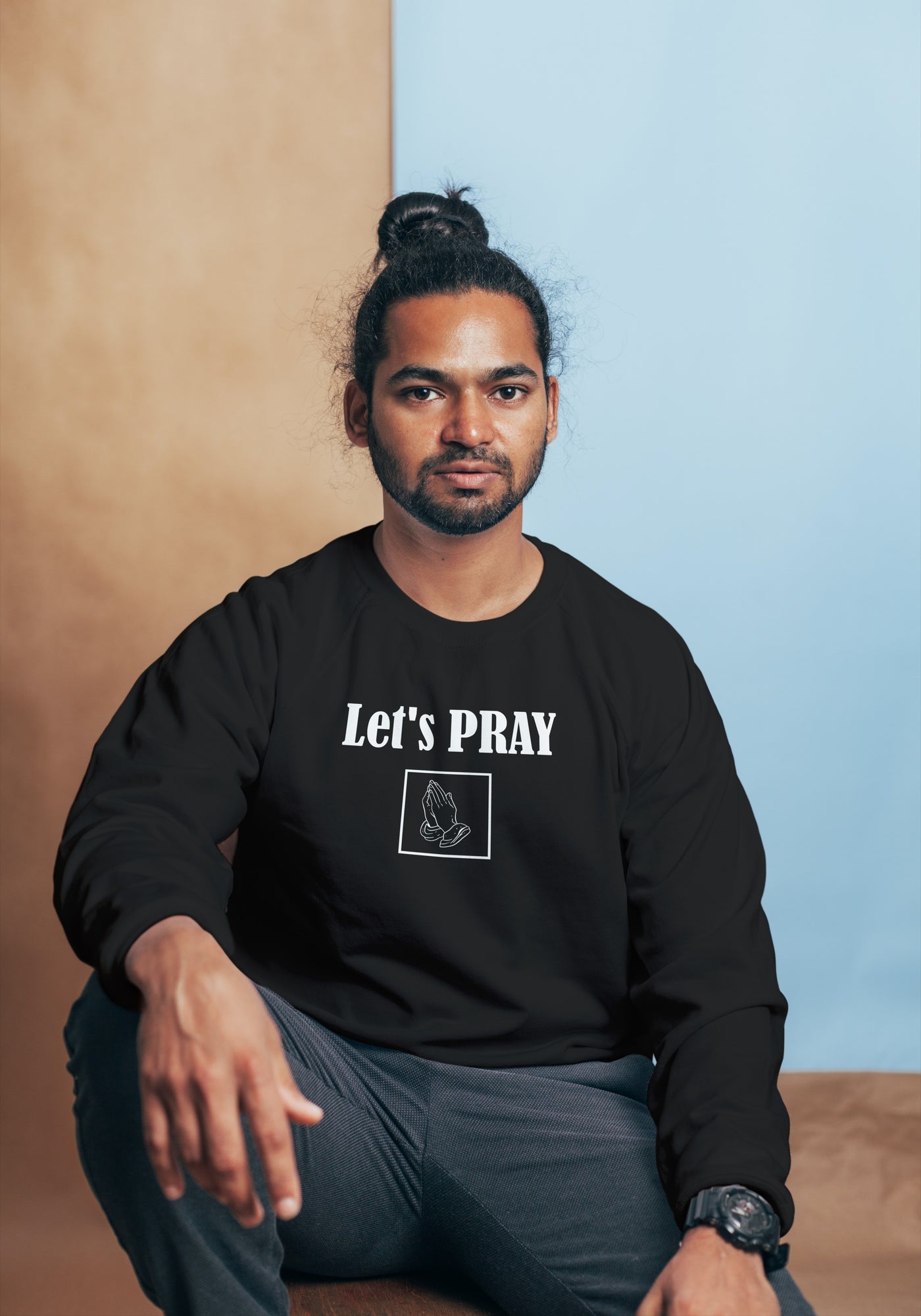 Praying Hands Men Sweatshirt. Sweatshirt shows words in white and image of praying hands in a square shape. Sweatshirt shown in black.